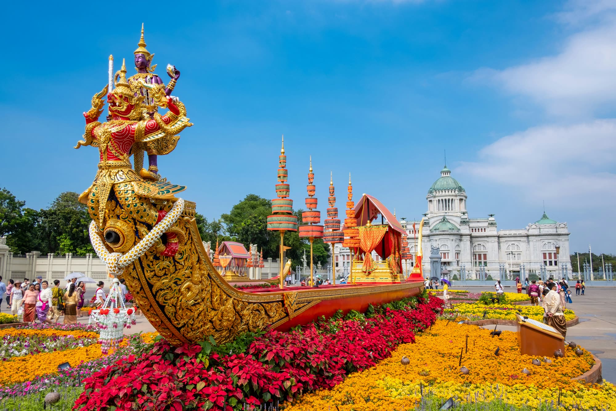 A golden royal barge sculpture and flower beds before the Ananta Samakhom Throne Hall, Bangkok