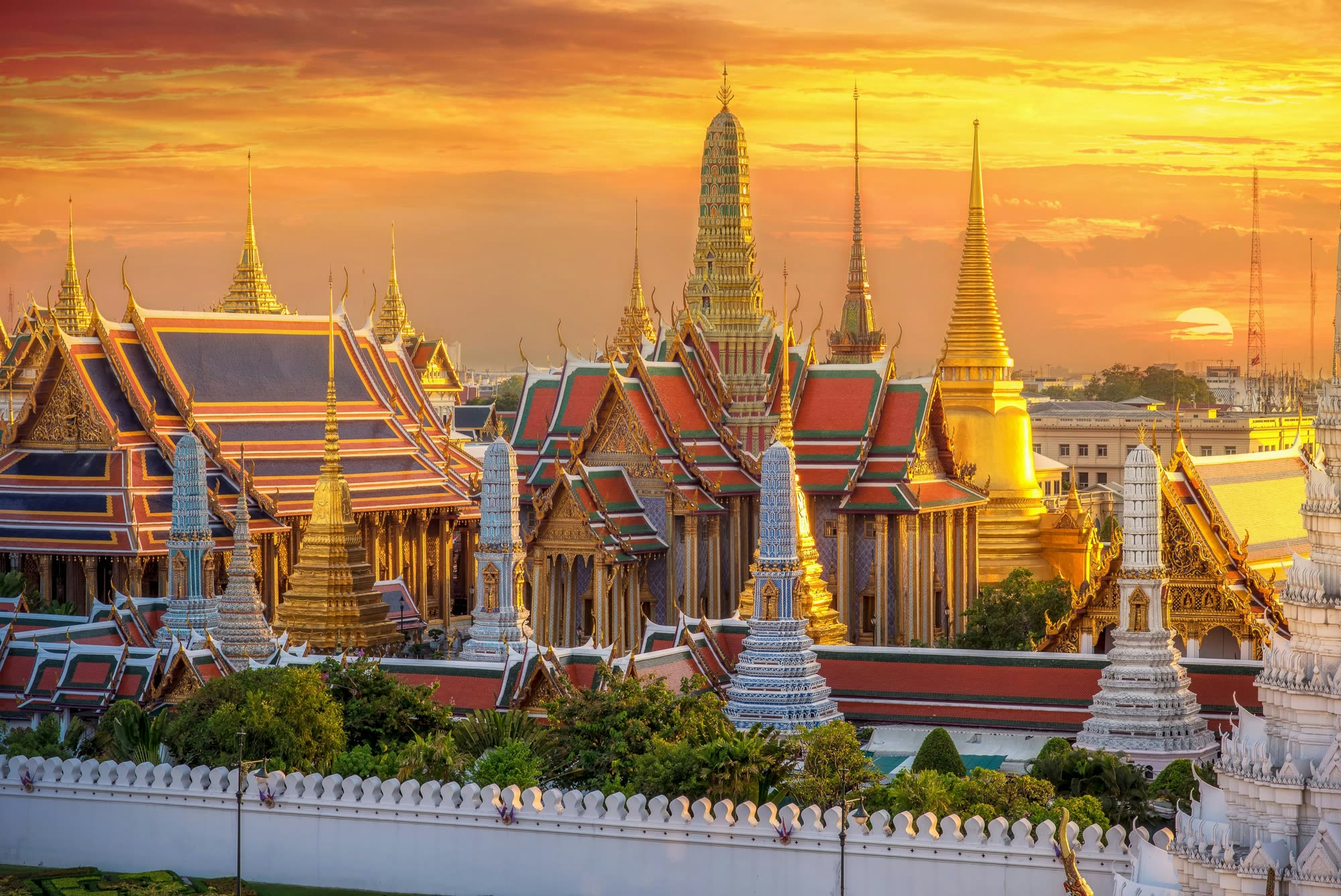 The Grand Palace and Wat Phra Kaew glowing at sunset in Bangkok